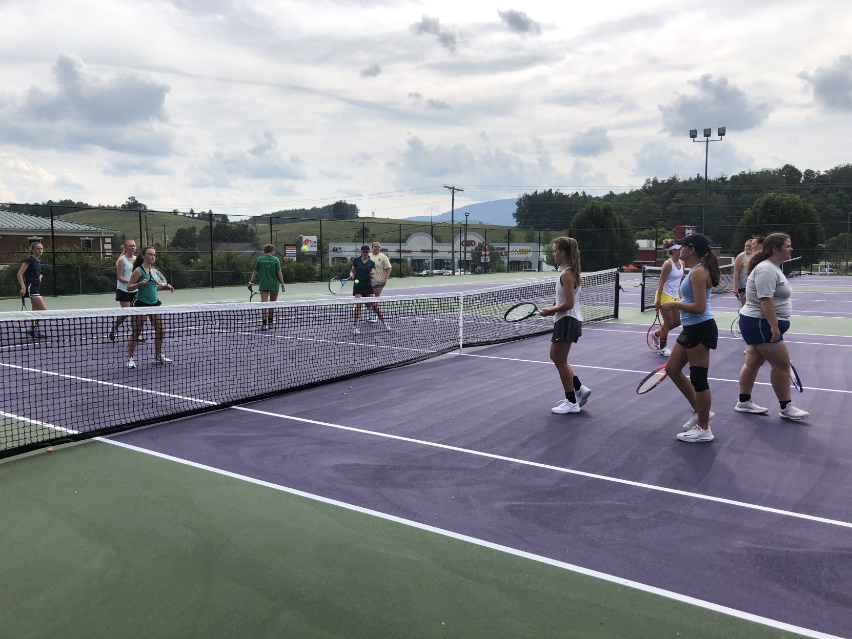 Lady Huskies tennis team holds first practice on new courts